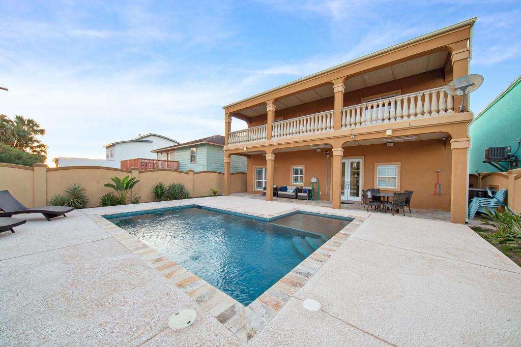 a house with a swimming pool in a yard at Once Upon a Tide in South Padre Island
