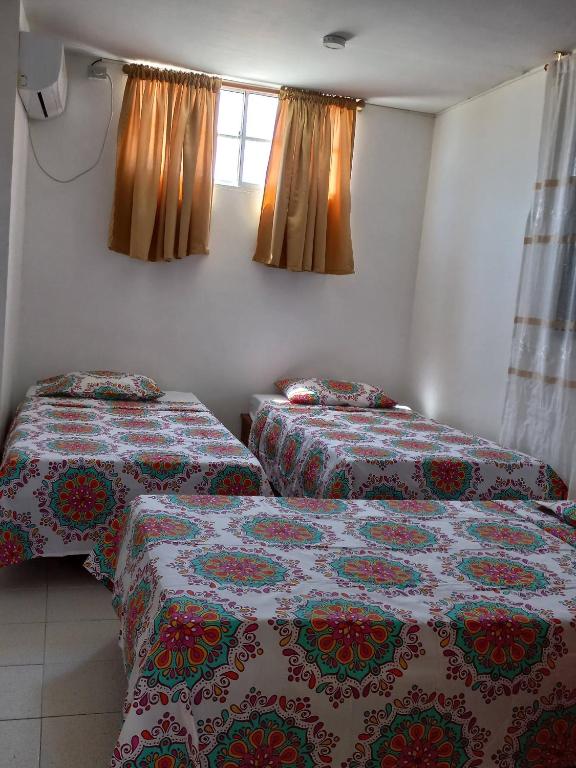 Postel nebo postele na pokoji v ubytování Hostal El Recreo