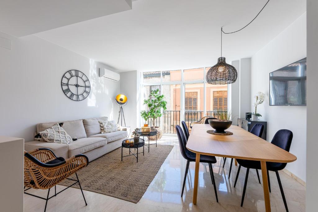 ein Wohnzimmer mit einem Sofa und einem Tisch in der Unterkunft Precioso apartamento en el centro con aparcamiento in Málaga