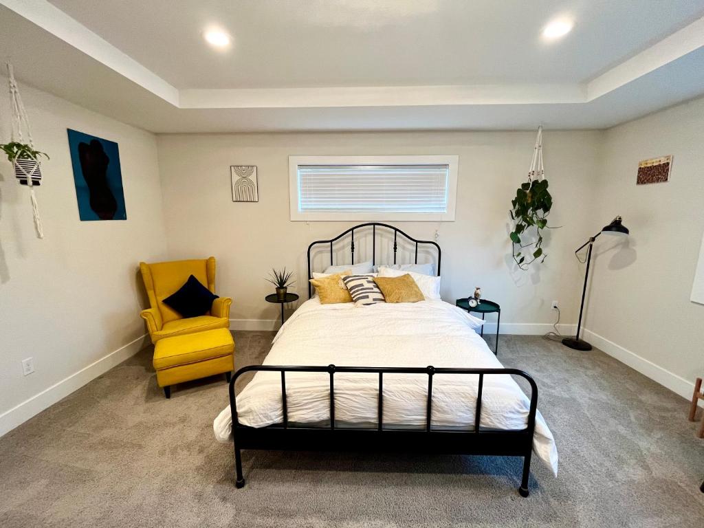 a bedroom with a bed and a yellow chair at Amorcito de Jenny - Shared House in Portland