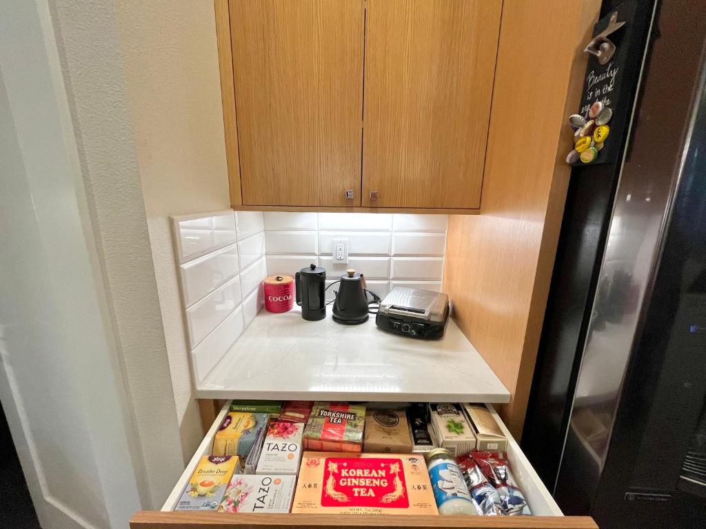 a kitchen with a drawer with food and a refrigerator at Amorcito de Jenny - Shared House in Portland