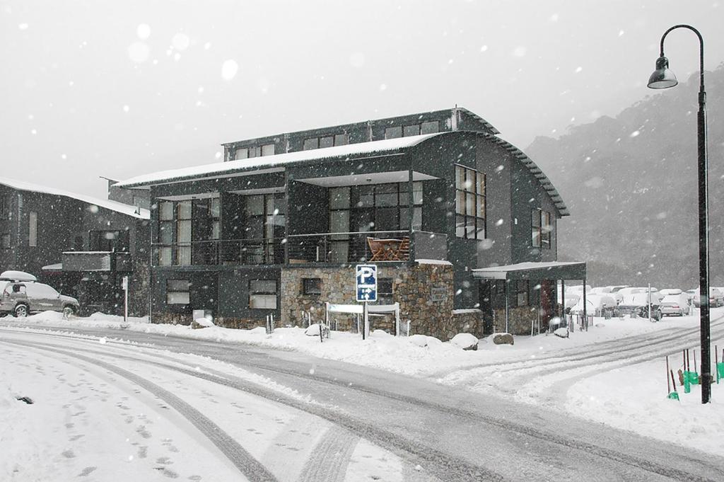 a large building on a street in the snow at Tomarlin Views 1 in Thredbo