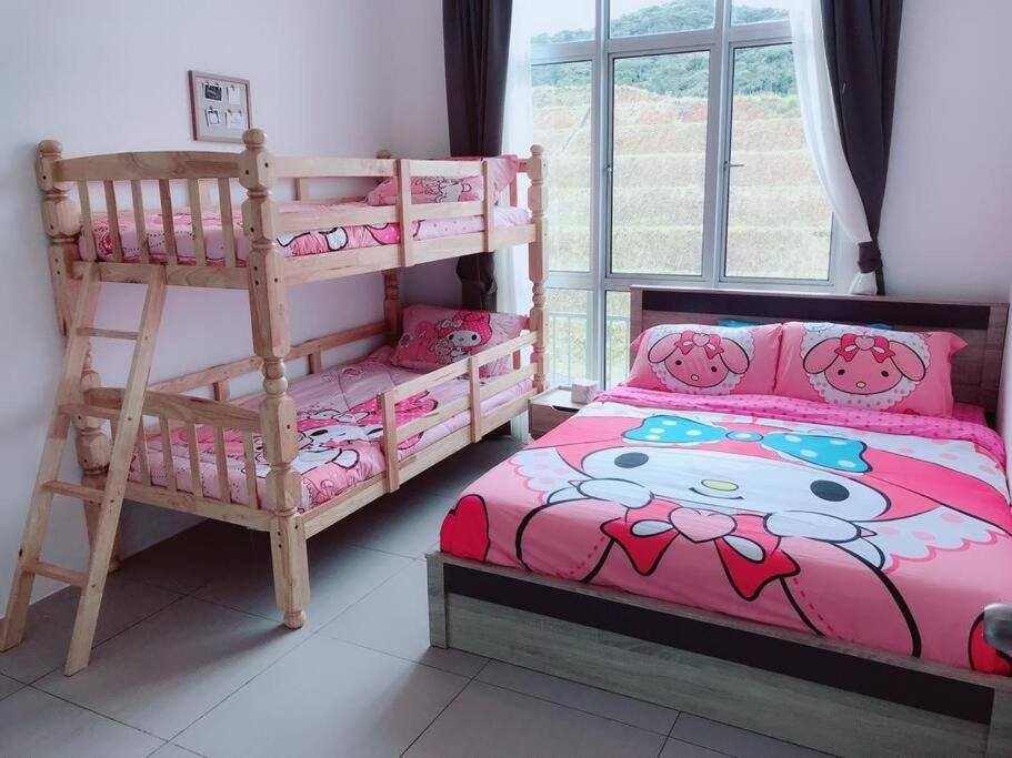 a bedroom with two bunk beds and a large window at W5WarmStay@Golden Hill/Penthouse/WiFi/3R/NightMarket/2CarPark in Brinchang