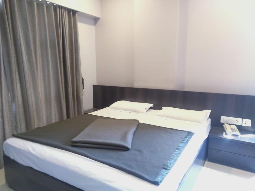 Postel nebo postele na pokoji v ubytování Sai Heera Residency Shirdi