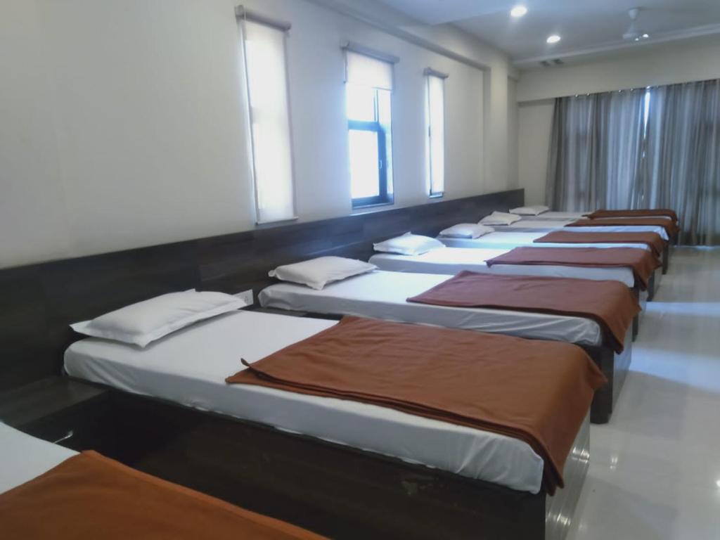 Postel nebo postele na pokoji v ubytování Sai Heera Residency Shirdi