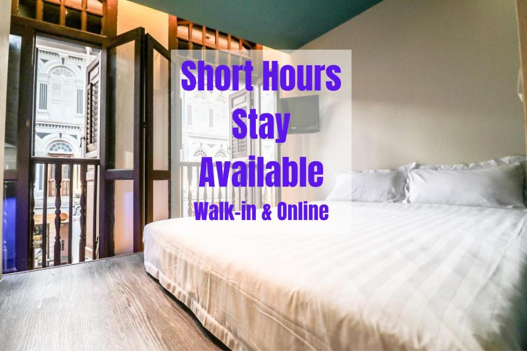 a bedroom with a bed with a sign that says shoot hours to stay available walk at Hotel Calmo Chinatown in Singapore