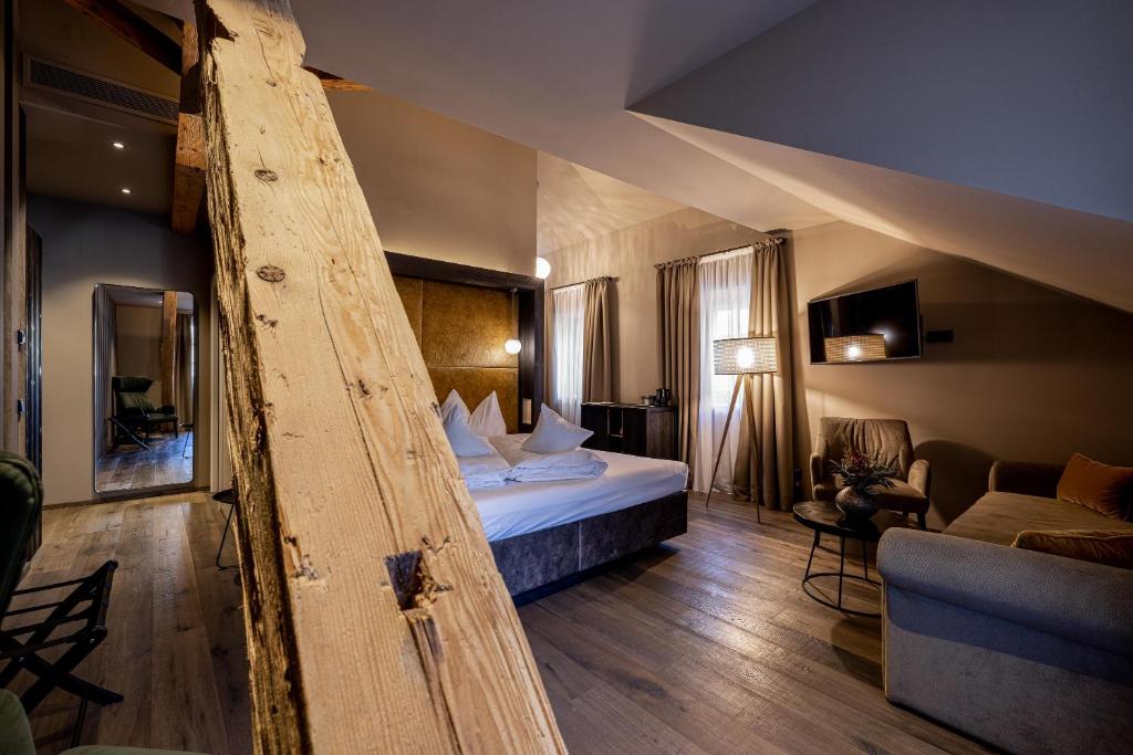 ein Hotelzimmer mit einem Bett und einem Sofa in der Unterkunft Eggentaler in Bozen