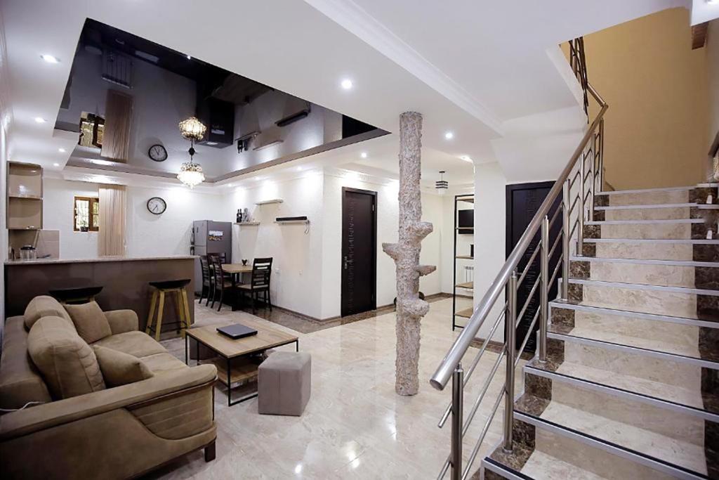 a large living room with a couch and a table at Nickos Hotel in Kutaisi