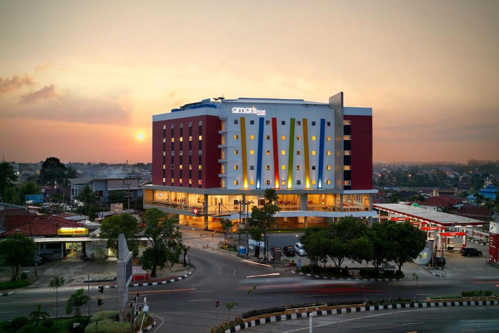 d'un grand bâtiment avec un même panneau dans une ville dans l'établissement Amaris Hotel Palembang, à Palembang