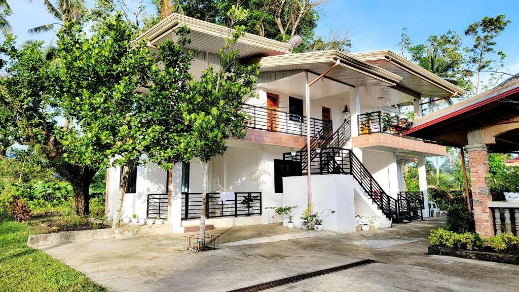 a white house with a staircase in front of it at Matilde B&B - La Paz, Carmen in Carmen