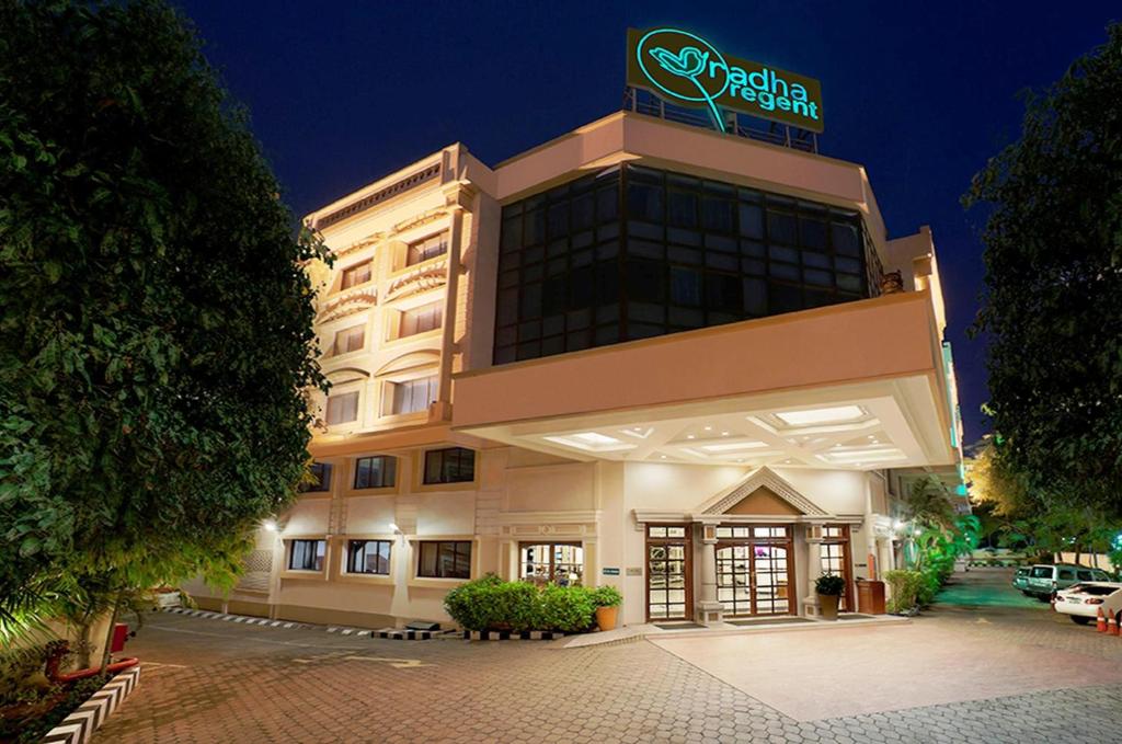 a hotel building with a sign on top of it at Radha Regent, Chennai in Chennai