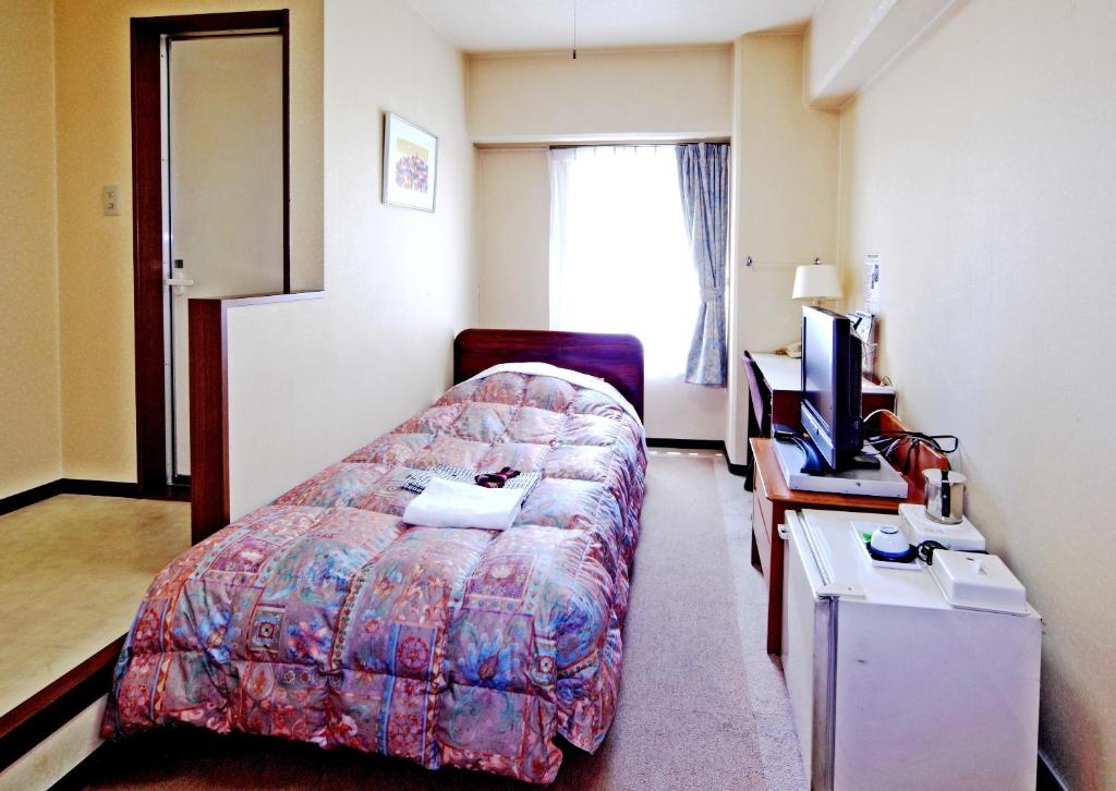 Postel nebo postele na pokoji v ubytování Hotel Sun Plaza Sakai