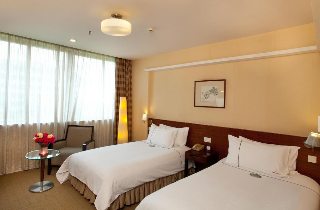 Postel nebo postele na pokoji v ubytování Liuhua Hotel