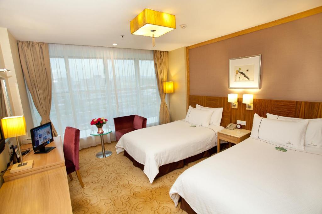 Postel nebo postele na pokoji v ubytování Liuhua Hotel