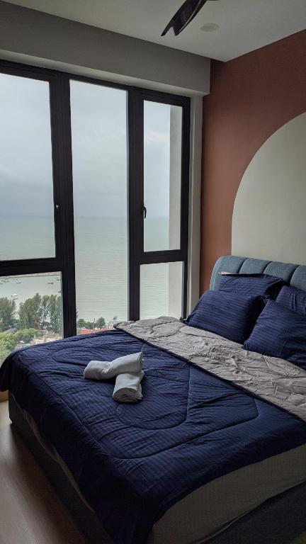 En eller flere senge i et værelse på Jazz 313 Cosy 2-Bedroom Suite with Pool & Seaview