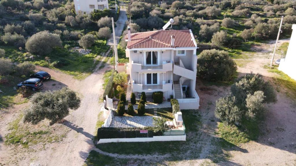 an aerial view of a white house with a car at Helen's Sounio Apartments in Sounio