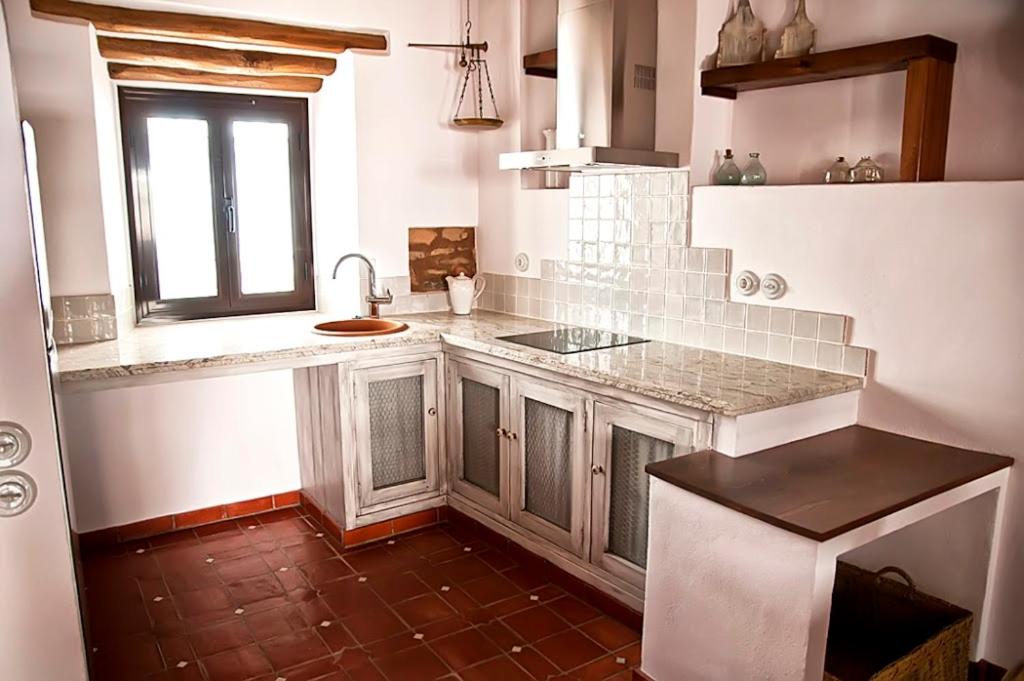 a kitchen with a counter and a sink and a window at CR La Cuadra in Constantina