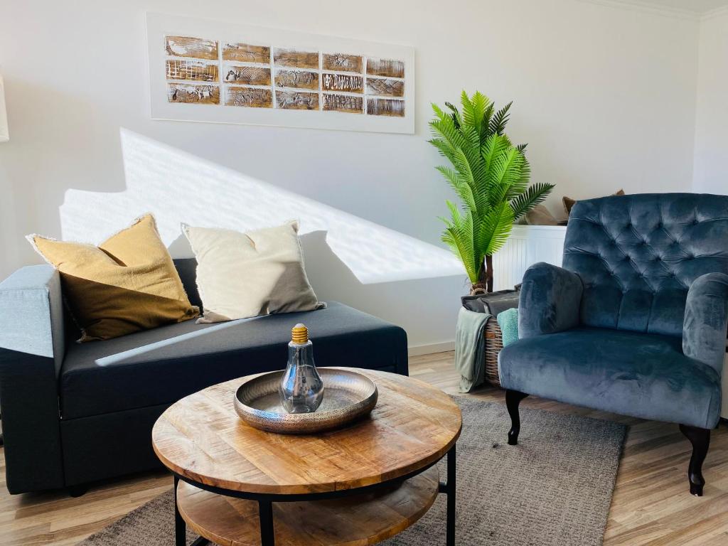 a living room with a couch and a table and a chair at Bike Hike Ski Brilon - Ferienappartment in Brilon