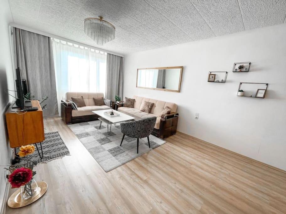 a living room with a couch and a table at Best Rated Central Apartment Vienna - AC, WiFi, 24-7 Self Check-In, Board games, Netflix, Prime in Vienna