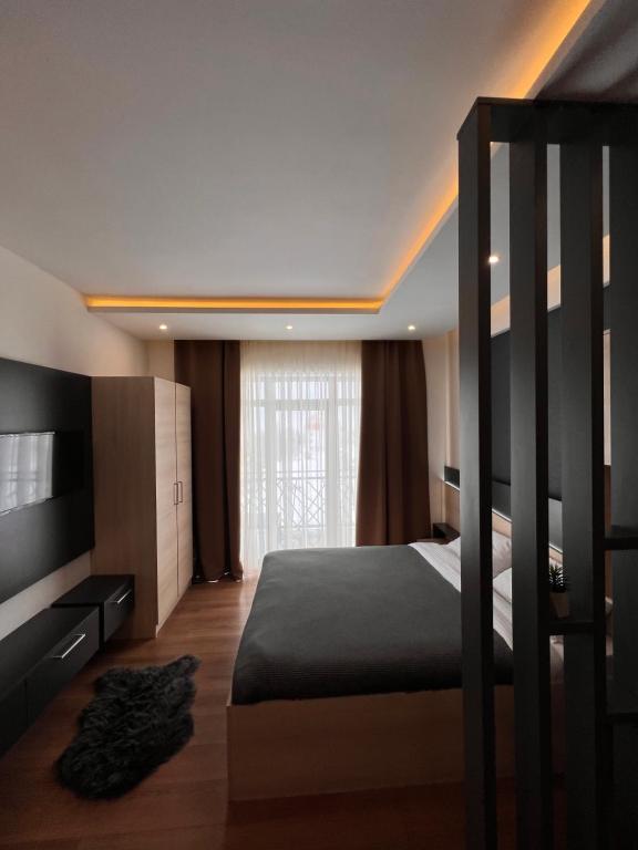 a bedroom with a bunk bed and a window at PresidentKop LUX Wellness & SPA Apartments in Kopaonik