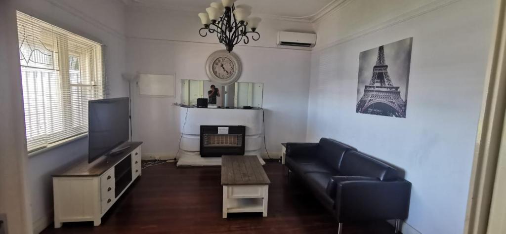 a living room with a couch and a fireplace at Fremantle Colonial Home in Fremantle