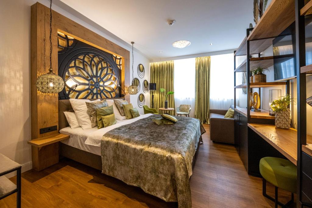a bedroom with a large bed with a large wooden headboard at Boutique Hotel Melchers in Vechta