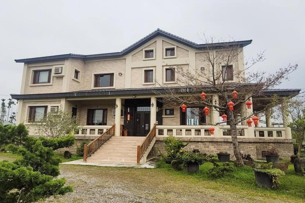 a large house with a staircase in front of it at 瑜家 Yoga Home in Chiayi City