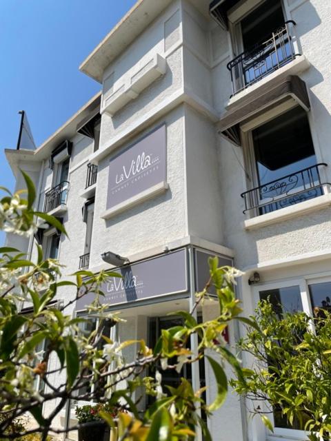 a building with a sign on the side of it at Hôtel La Villa Cannes in Cannes