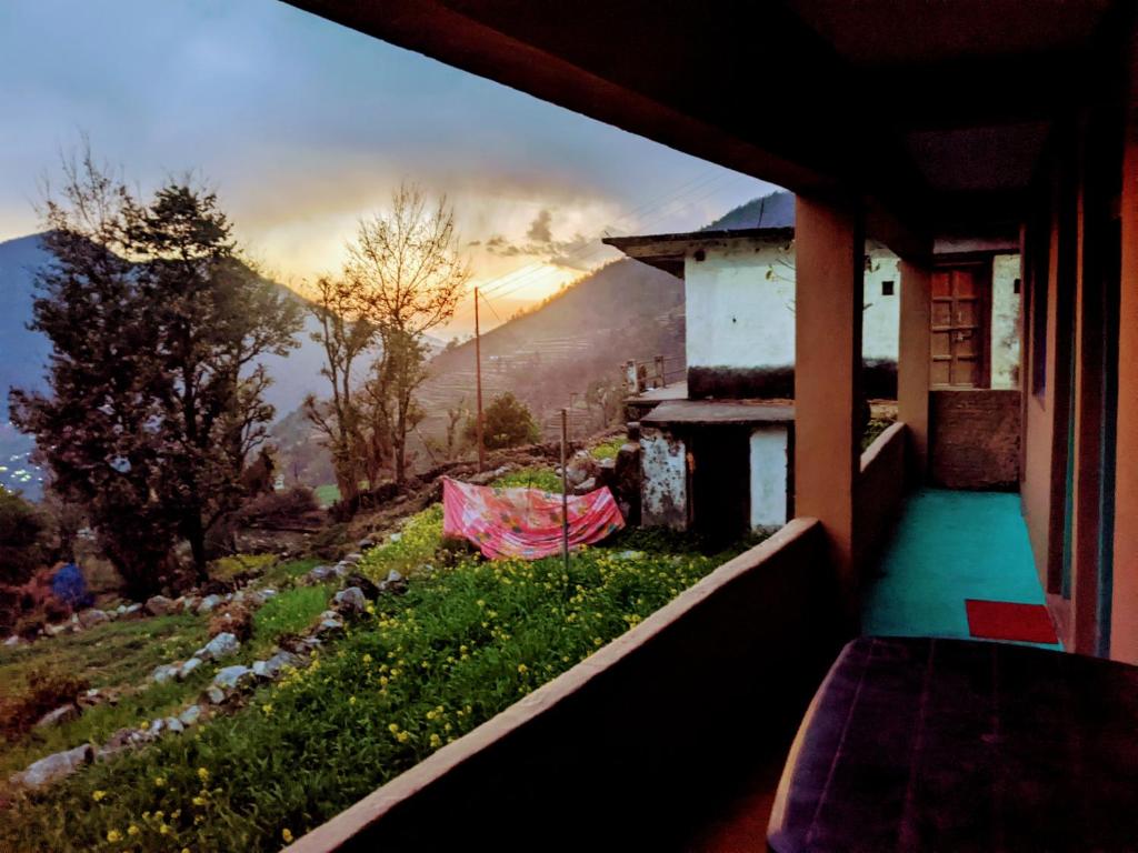 a balcony of a house with a view of a mountain at Moon hotel Tungnath in Chopta