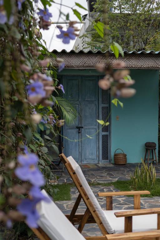 a blue house with a chair and a blue door at Ekaa Hotel in Palomino