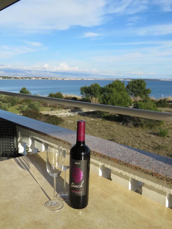 a bottle of wine sitting on a table with a glass at Apartman Vir Gogo br 5 in Vir