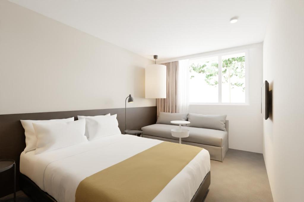 Postel nebo postele na pokoji v ubytování Hotel Cupidon