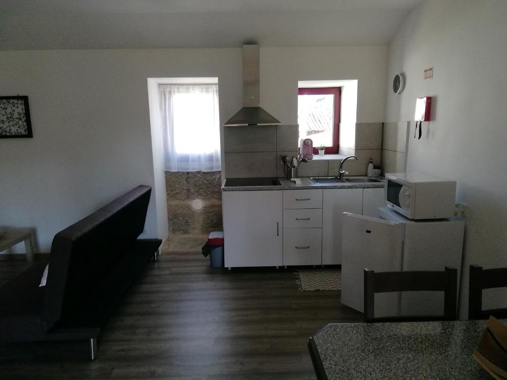 a kitchen with a sink and a counter top at RESIDENCIAS VINHA VELHA in Ponte da Barca