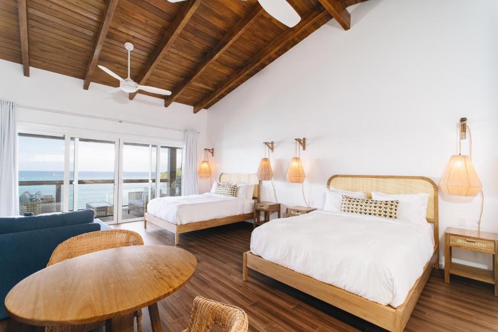 Voodi või voodid majutusasutuse The Beach House Boutique Hotel toas