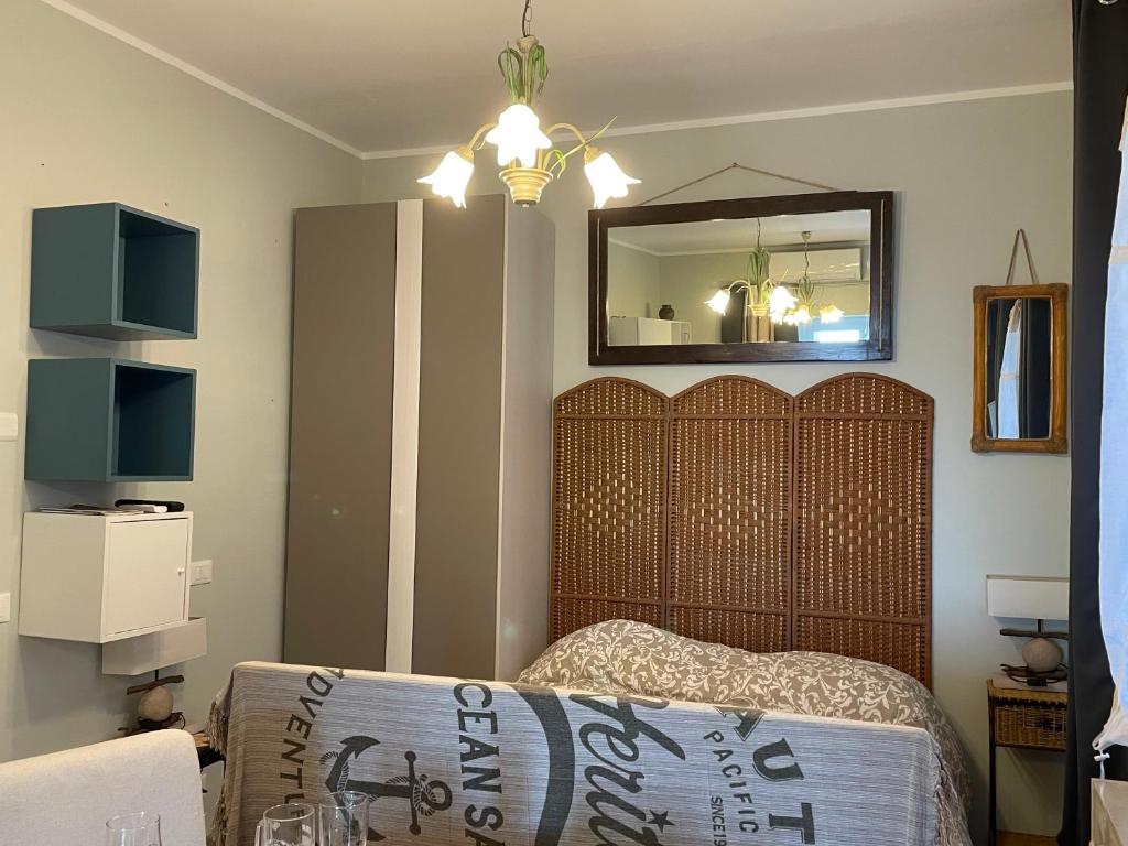 a bedroom with a bed and a mirror on the wall at Casa del sasso in Bergeggi