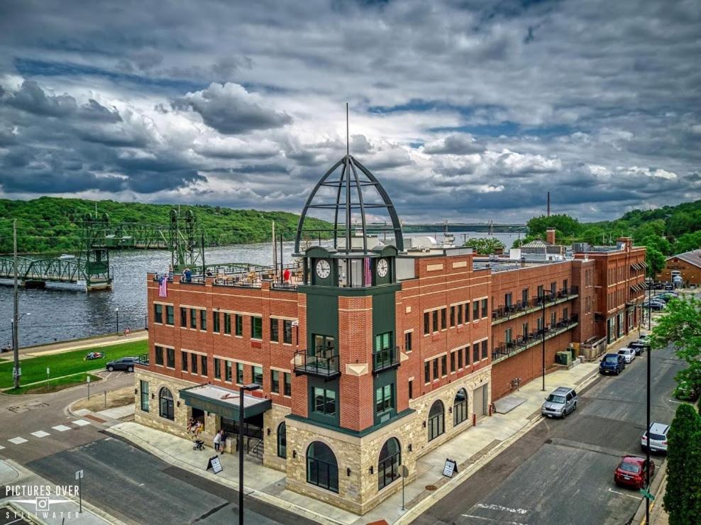 a large brick building with a clock tower on top at Water Street Inn in Stillwater