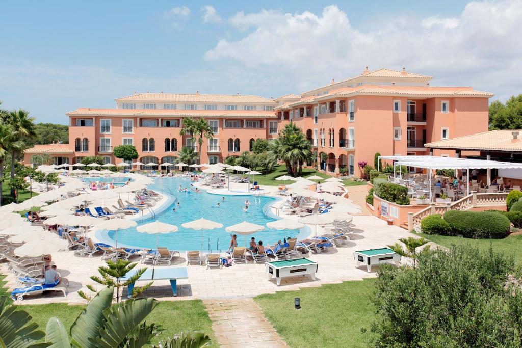 an image of a resort with a large swimming pool at Grupotel Macarella Suites & Spa in Son Xoriguer