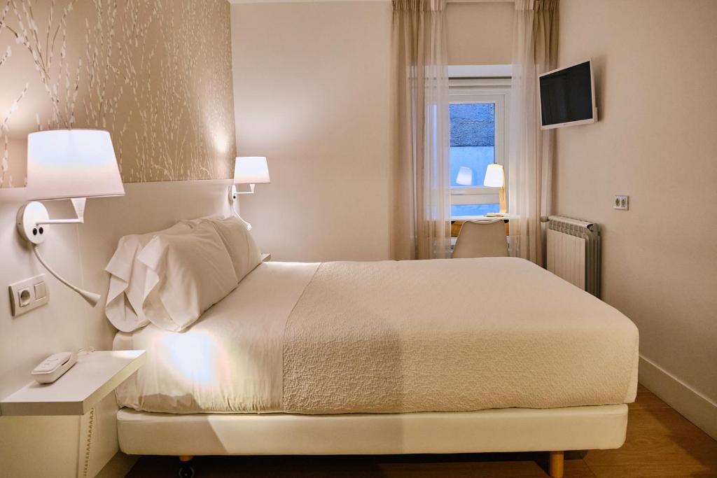 Cama o camas de una habitación en Hostal Suso