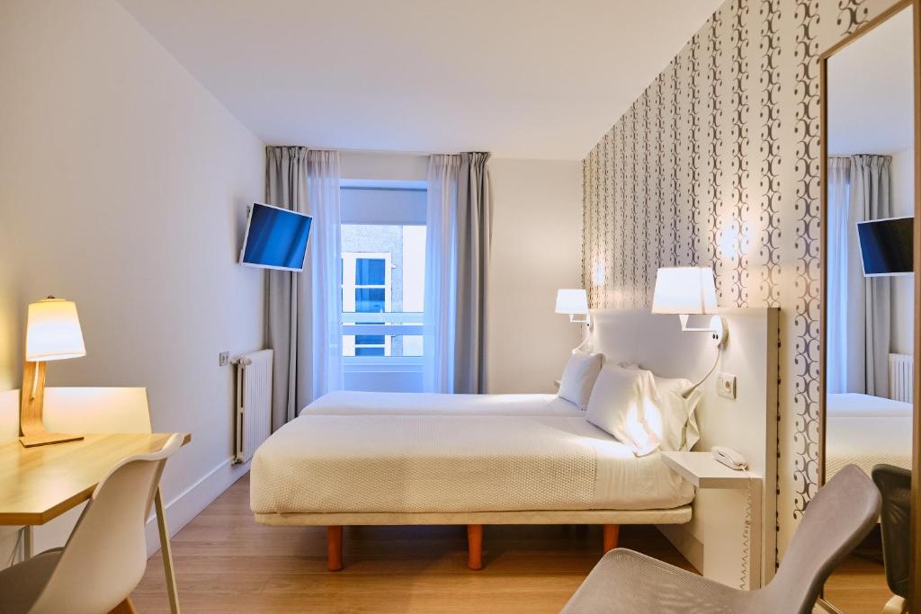 Cama o camas de una habitación en Hostal Suso