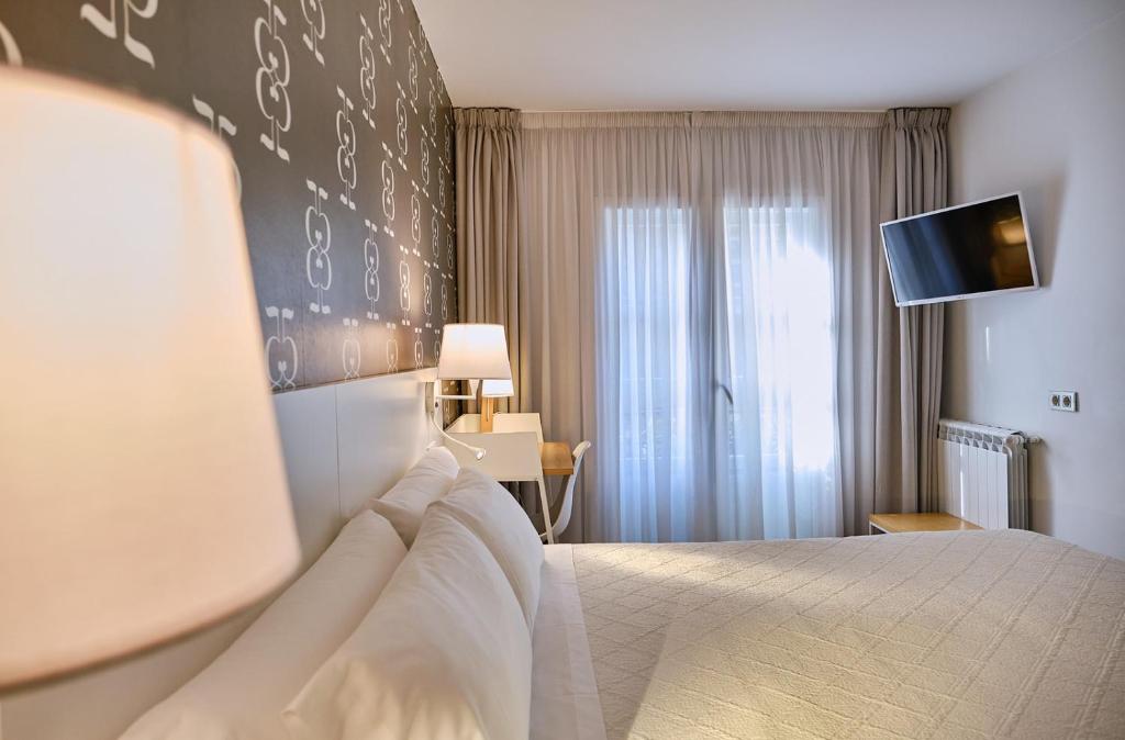 Cama o camas de una habitación en Hostal Suso