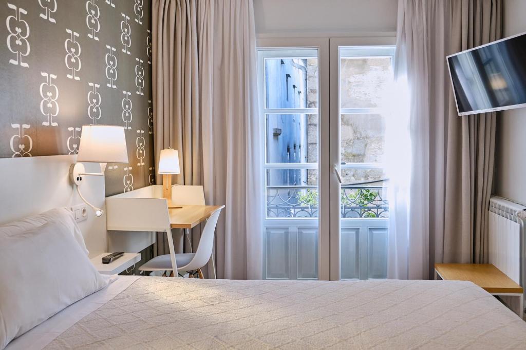 Cama o camas de una habitación en Hostal Suso