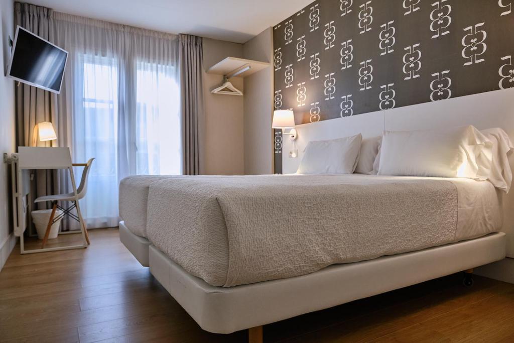 Cama o camas de una habitación en Hostal Suso