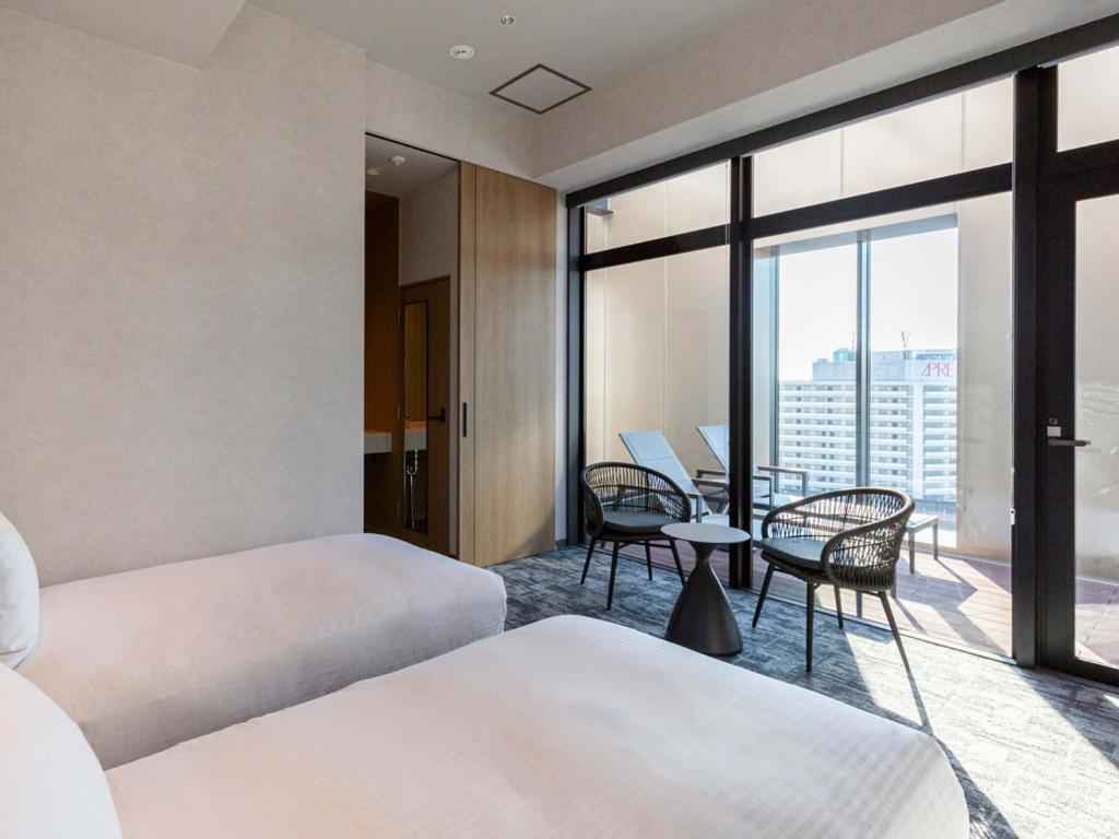 Postel nebo postele na pokoji v ubytování Akabane Holic Hotel