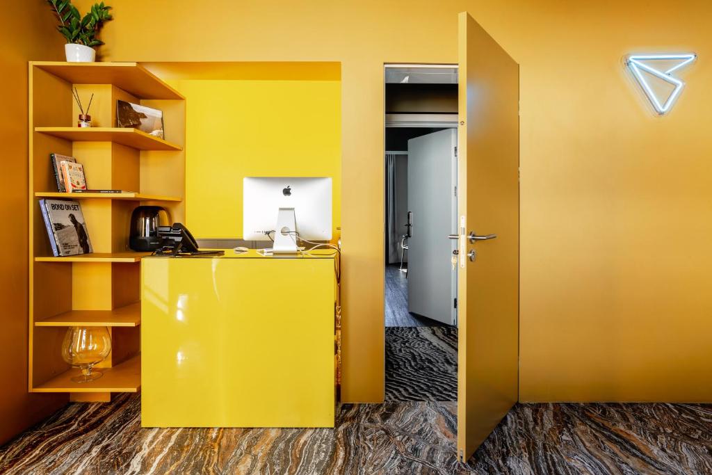 an office with yellow walls and a yellow door at Бутик-отель География in Irkutsk