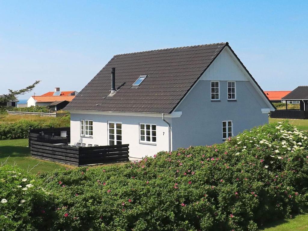 a white house with a black roof at 14 person holiday home in L kken in Løkken
