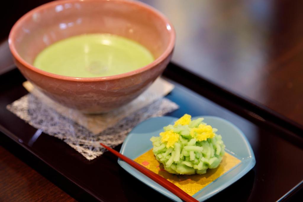 a bowl of soup and a plate of food at Kanazawa Hakuchoro Hotel Sanraku -Natural Hot Spring- in Kanazawa