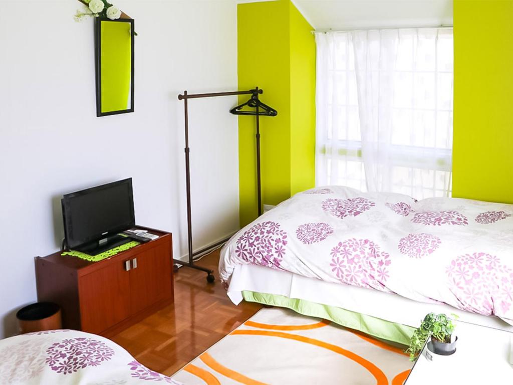 Postel nebo postele na pokoji v ubytování Guest House Shirahama R-cafe - Female Only
