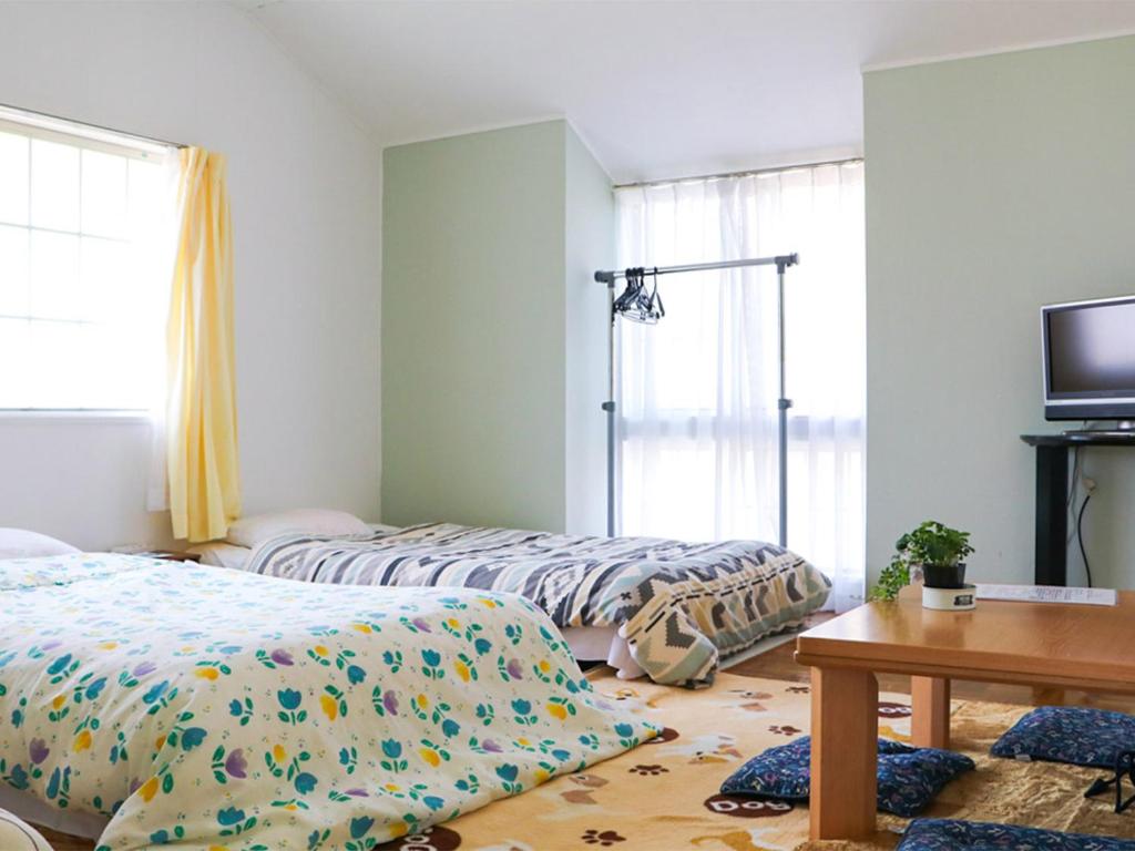 Postel nebo postele na pokoji v ubytování Guest House Shirahama R-cafe - Female Only