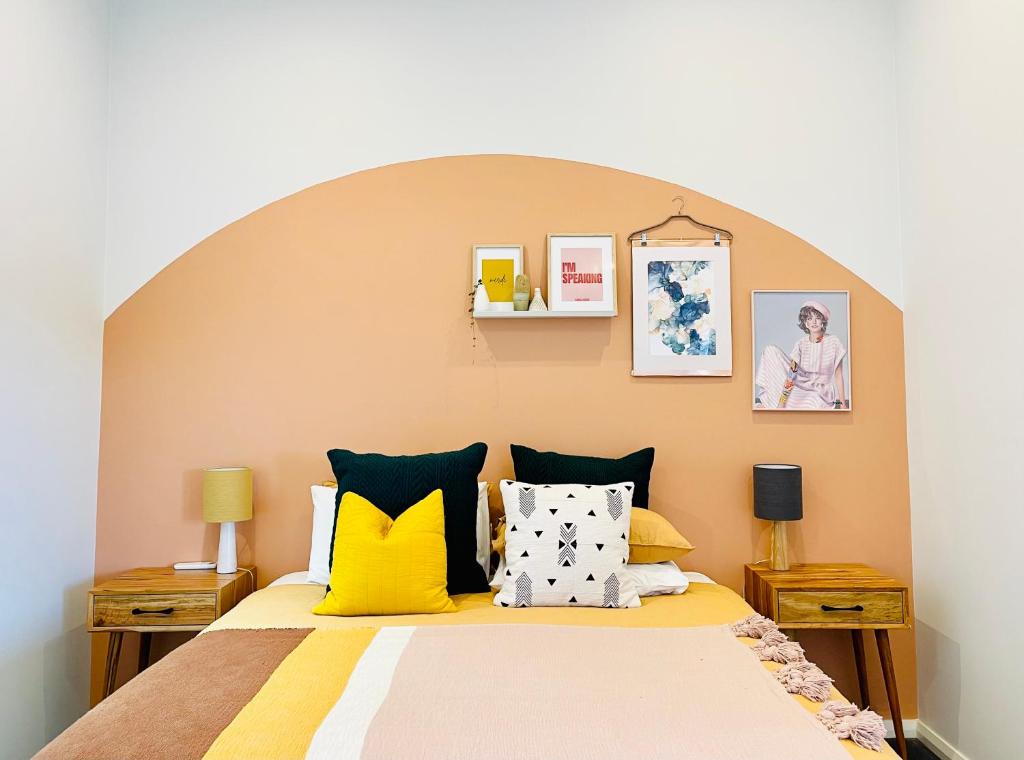 a bedroom with a large bed with yellow and white pillows at 734 apartment-2 bedroom and 2 bathroom accommodation, sleeps 4 in Margaret River Town