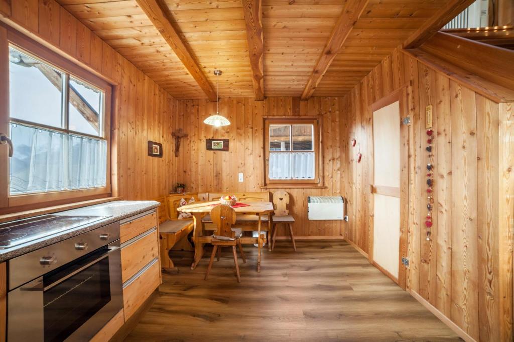 a kitchen with a table and a dining room at Ferienhaus Waldhof in Naturno